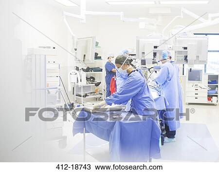 Team of surgeons performing surgery in operating theater View Large Photo Image Stock Image - Team of surgeons performing surgery in operating theater. Fotosearch