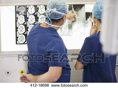 Two doctors discussing patient's x-ray and MRI scans View Large Photo Image Stock Photo - Two doctors discussing patient's x-ray and MRI scans. Fotosearch