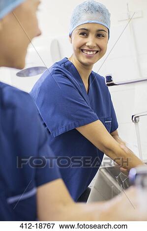 Two female surgeons washing hands in hospital View Large Photo Image Stock Photo - Two female surgeons washing hands in hospital. Fotosearch