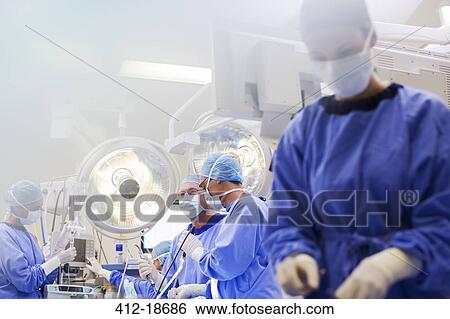 Young nurse preparing medical equipment during surgery View Large Photo Image Stock Photograph - Young nurse preparing medical equipment during surgery. Fotosearch