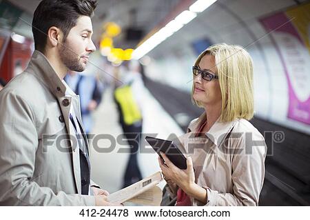 Business people talking in subway station View Large Photo Image Stock Photo - Business people talking in subway station. Fotosearch