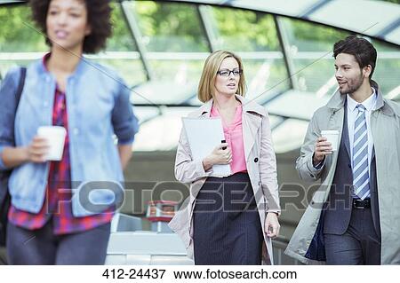 Stock Photo - Business people talking in train station. Fotosearch