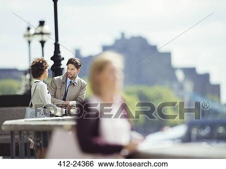 Stock Photograph - Business people talking on city waterfront. Fotosearch