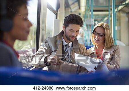 Business people talking on train View Large Photo Image Stock Image - Business people talking on train. Fotosearch