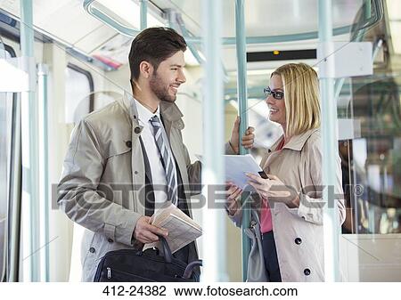 Business people talking on train View Large Photo Image Stock Image - Business people talking on train. Fotosearch