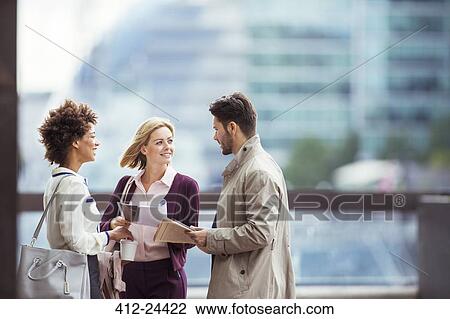Business people talking outdoors View Large Photo Image Stock Image - Business people talking outdoors. Fotosearch