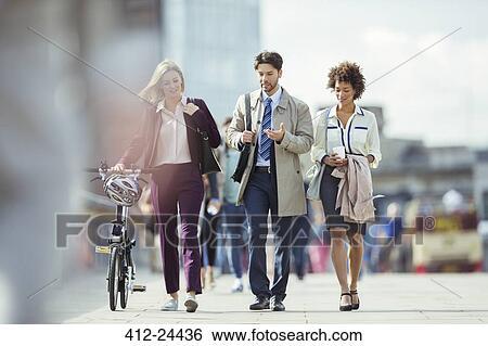 Business people walking and talking in city View Large Photo Image Stock Photograph - Business people walking and talking in city. Fotosearch