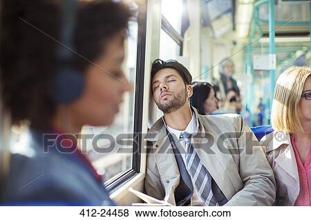 Businessman napping on train View Large Photo Image Stock Photo - Businessman napping on train. Fotosearch