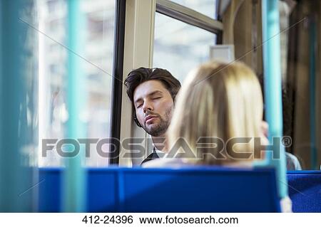 Businessman napping on train View Large Photo Image Stock Photograph - Businessman napping on train. Fotosearch
