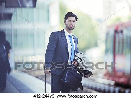 Businessman waiting at train station View Large Photo Image Stock Photo - Businessman waiting at train station. Fotosearch