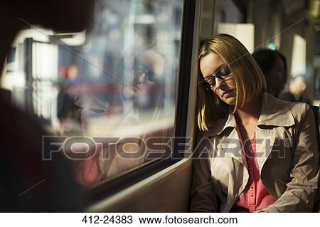 Businesswoman napping on train View Large Photo Image Stock Image - Businesswoman napping on train. Fotosearch