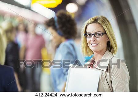Businesswoman smiling in train station View Large Photo Image Picture - Businesswoman smiling in train station. Fotosearch
