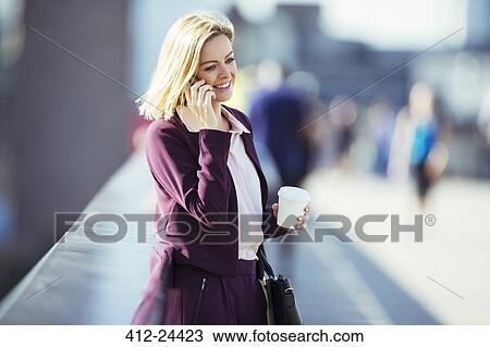 Businesswoman talking on cell phone on urban bridge View Large Photo Image Stock Image - Businesswoman talking on cell phone on urban bridge. Fotosearch