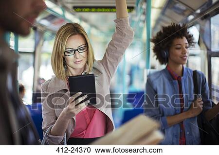 Businesswoman using digital tablet on train View Large Photo Image Stock Image - Businesswoman using digital tablet on train. Fotosearch