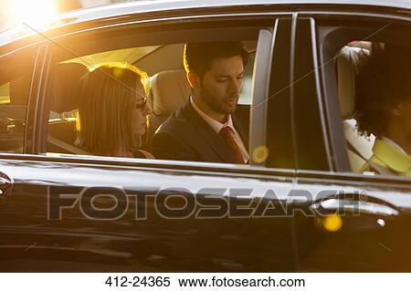 Passengers in back seat of black car View Large Photo Image Stock Photography - Passengers in back seat of black car. Fotosearch