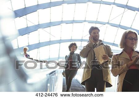 People riding escalator View Large Photo Image Stock Photograph - People riding escalator. Fotosearch