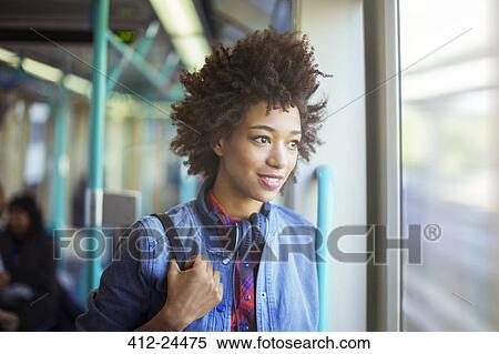 Stock Photography - Woman looking out window of train. Fotosearch