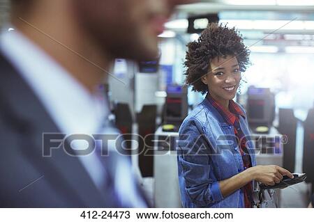 Woman smiling in train station View Large Photo Image Stock Image - Woman smiling in train station. Fotosearch