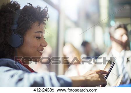 Woman using digital tablet on train View Large Photo Image Stock Photography - Woman using digital tablet on train. Fotosearch