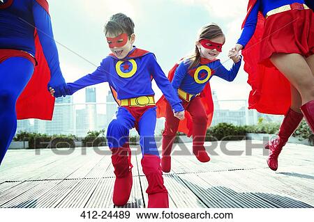 Family of superheroes running on city rooftop View Large Photo Image Stock Photo - Family of superheroes running on city rooftop. Fotosearch