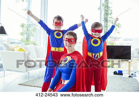 Superhero children and mother smiling in living room View Large Photo Image Stock Image - Superhero children and mother smiling in living room. Fotosearch