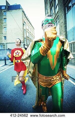 Superhero couple running on city street View Large Photo Image Stock Image - Superhero couple running on city street. Fotosearch