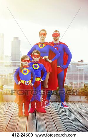 Superhero family standing on city rooftop View Large Photo Image Stock Image - Superhero family standing on city rooftop. Fotosearch