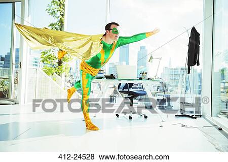 Superhero flying in office View Large Photo Image Stock Photo - Superhero flying in office. Fotosearch