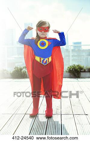 Superhero girl flexing muscles on city rooftop View Large Photo Image Stock Image - Superhero girl flexing muscles on city rooftop. Fotosearch