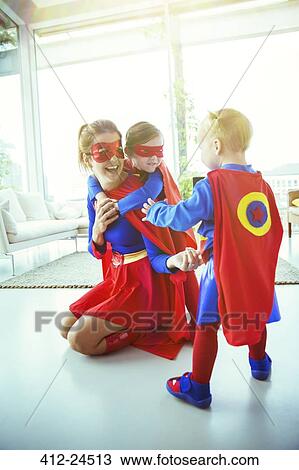 Superhero mother and children playing in living room View Large Photo Image Stock Image - Superhero mother and children playing in living room. Fotosearch