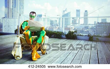 Superhero reading newspaper on city rooftop View Large Photo Image Stock Photography - Superhero reading newspaper on city rooftop. Fotosearch
