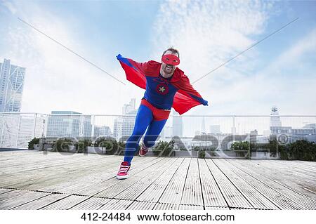 Superhero running with cape on city rooftop View Large Photo Image Picture - Superhero running with cape on city rooftop. Fotosearch