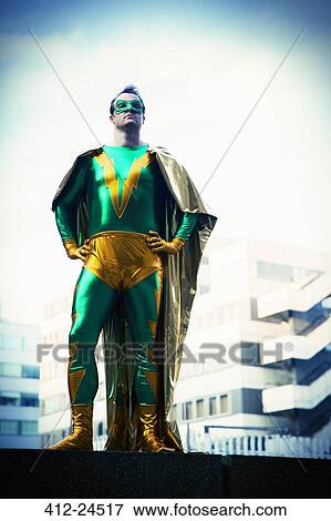 Superhero standing near city skyline View Large Photo Image Stock Photo - Superhero standing near city skyline. Fotosearch