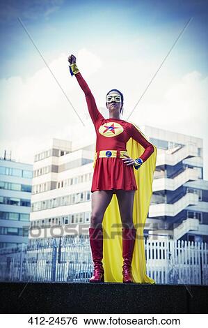 Superhero standing proudly in city View Large Photo Image Stock Photograph - Superhero standing proudly in city. Fotosearch