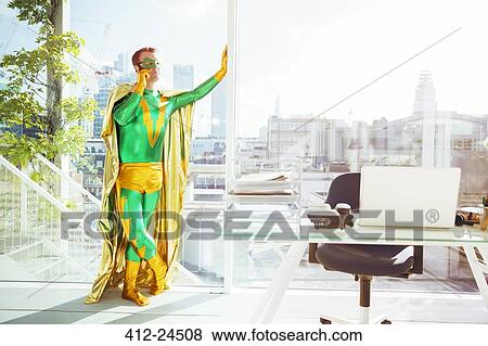 Superhero talking on cell phone in office View Large Photo Image Stock Photo - Superhero talking on cell phone in office. Fotosearch