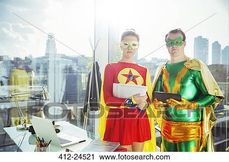Superheroes standing in office View Large Photo Image Stock Image - Superheroes standing in office. Fotosearch