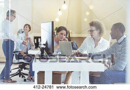 Stock Image - Group of office workers at work. Fotosearch