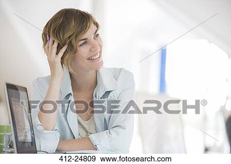 "holding hand in hair, Portrait of woman with laptop smiling" View Large Photo Image Stock Photo - "holding hand in hair, Portrait of woman with laptop smiling". Fotosearch