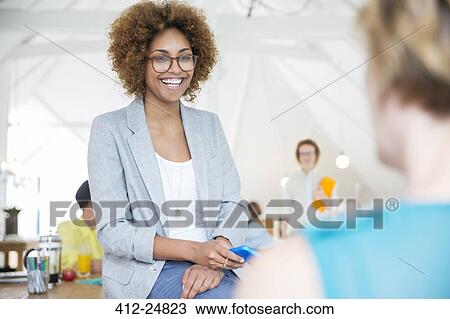 "holding smart phone and smiling in office, Portrait of woman wearing spectacles" View Large Photo Image Stock Image - "holding smart phone and smiling in office, Portrait of woman wearing spectacles". Fotosearch