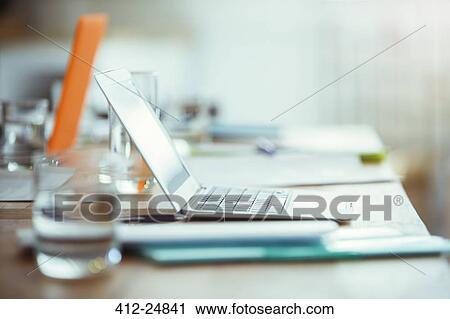 "Office supplies, laptop and glass of water on desk in office" View Large Photo Image Stock Image - "Office supplies, laptop and glass of water on desk in office". Fotosearch