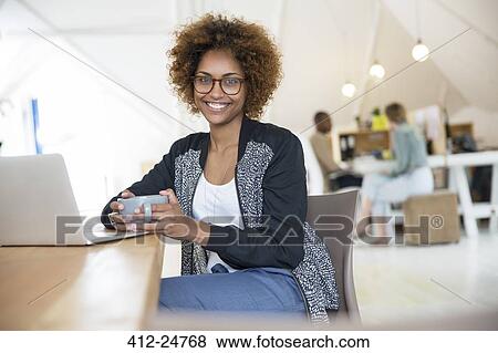 Office worker with coffee using laptop View Large Photo Image Stock Photo - Office worker with coffee using laptop. Fotosearch
