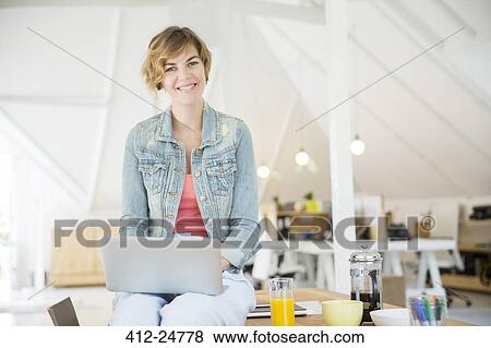 Office worker with coffee using laptop View Large Photo Image Stock Photo - Office worker with coffee using laptop. Fotosearch