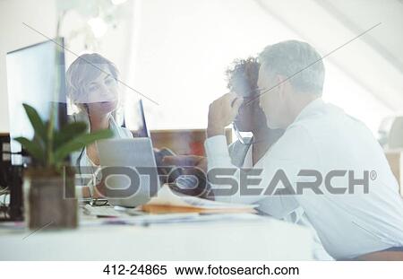 Office workers planning at desk View Large Photo Image Stock Photography - Office workers planning at desk. Fotosearch