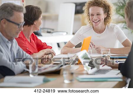 People talking and smiling during business meeting View Large Photo Image Stock Photo - People talking and smiling during business meeting. Fotosearch