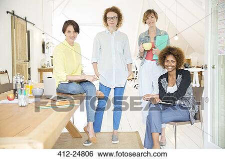 Portrait of female office team smiling in office View Large Photo Image Stock Photograph - Portrait of female office team smiling in office. Fotosearch
