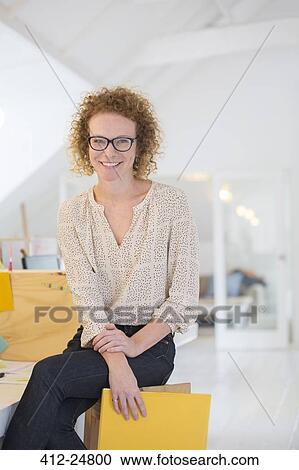 Portrait of laughing office worker holding file View Large Photo Image Stock Image - Portrait of laughing office worker holding file. Fotosearch