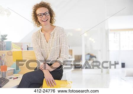 Portrait of laughing office worker holding file View Large Photo Image Stock Photograph - Portrait of laughing office worker holding file. Fotosearch