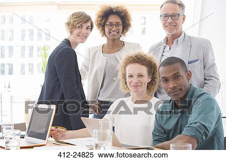 Stock Photography - Portrait of office team smiling in conference room. Fotosearch