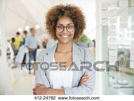 Portrait of smiling office worker with crossed arms View Large Photo Image Stock Image - Portrait of smiling office worker with crossed arms. Fotosearch