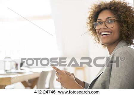 Portrait of smiling office worker with smart phone View Large Photo Image Stock Photograph - Portrait of smiling office worker with smart phone. Fotosearch